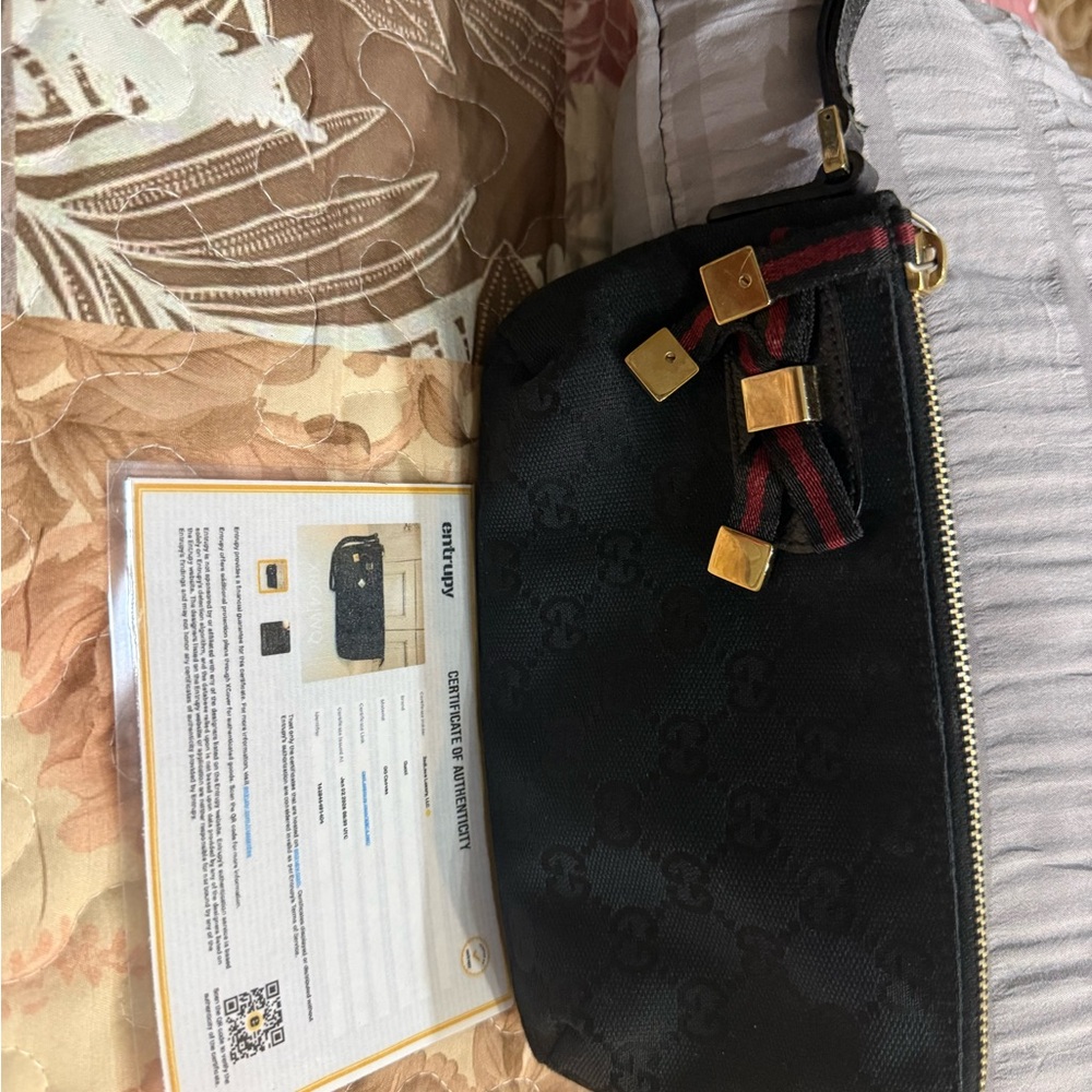 Gucci black canvas wristlet with red and green web ribbon and gold hardware